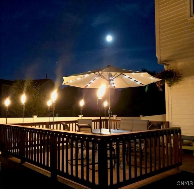 3 Foxwood Dr, Lysander, NY 13027 - patio at night featuring a deck and outdoor dining space
