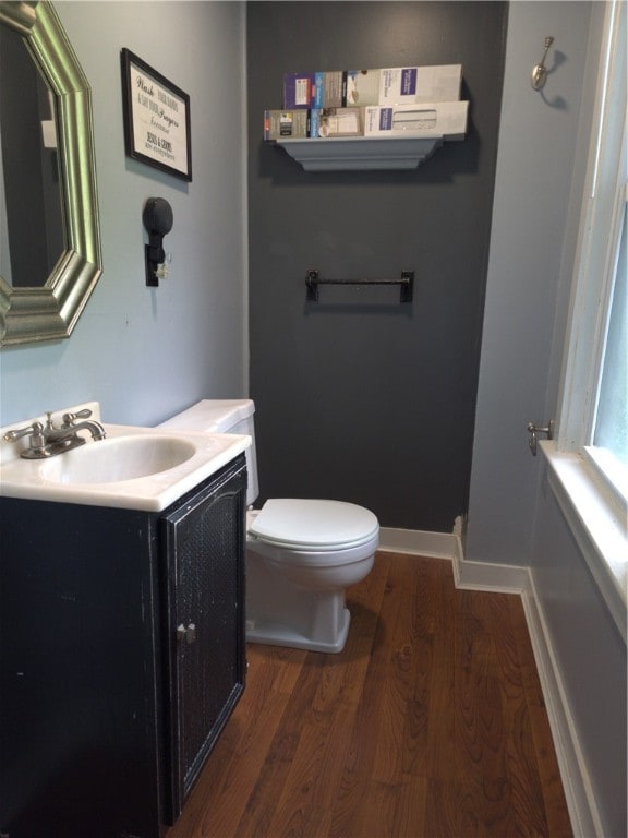 133 California Dr, Greece, NY 14616 - bathroom with wood finished floors, vanity, toilet, and baseboards