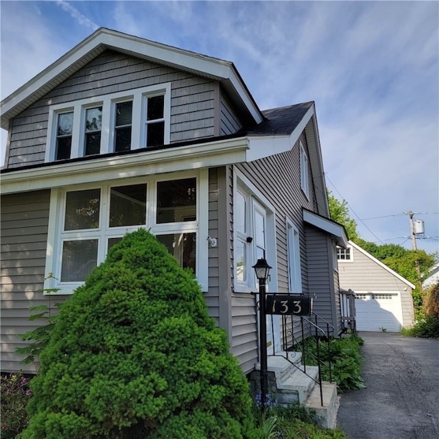 133 California Dr, Greece, NY 14616 - view of front facade featuring an outbuilding and a garage