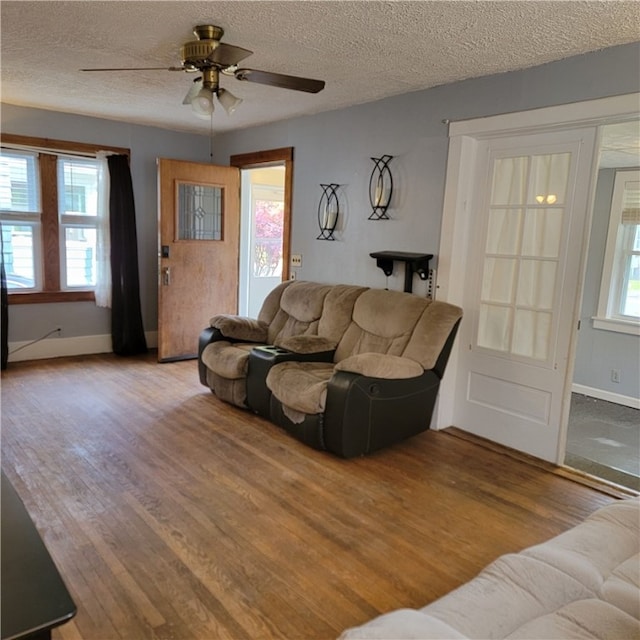 133 California Dr, Greece, NY 14616 - living area with wood finished floors, baseboards, a ceiling fan, and a textured ceiling