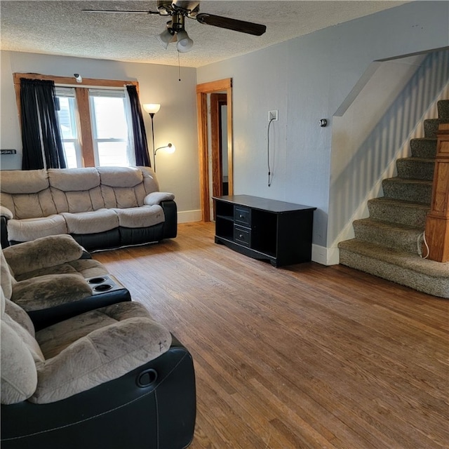 133 California Dr, Greece, NY 14616 - living area with baseboards, a ceiling fan, wood finished floors, stairway, and a textured ceiling
