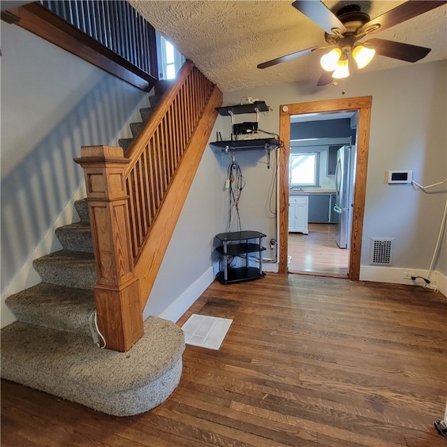 133 California Dr, Greece, NY 14616 - stairs featuring baseboards, ceiling fan, wood finished floors, and a textured ceiling