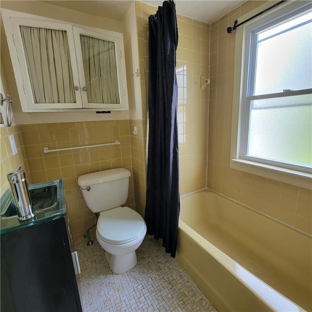 133 California Dr, Greece, NY 14616 - full bath with toilet, tile walls, vanity, shower / tub combo with curtain, and tile patterned floors