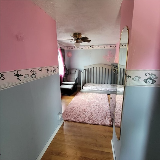 133 California Dr, Greece, NY 14616 - bedroom featuring wood finished floors, a textured ceiling, and a ceiling fan