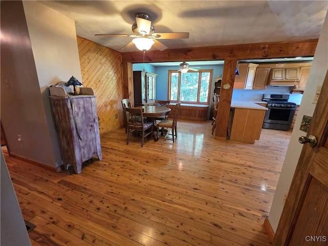 4300 Mutton Hill Rd, Fenner, NY 13035 - dining room featuring light wood finished floors, a ceiling fan, and wooden walls