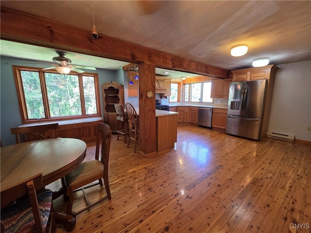 4300 Mutton Hill Rd, Fenner, NY 13035 - kitchen featuring appliances with stainless steel finishes, a baseboard radiator, light wood-style floors, a sink, and light countertops