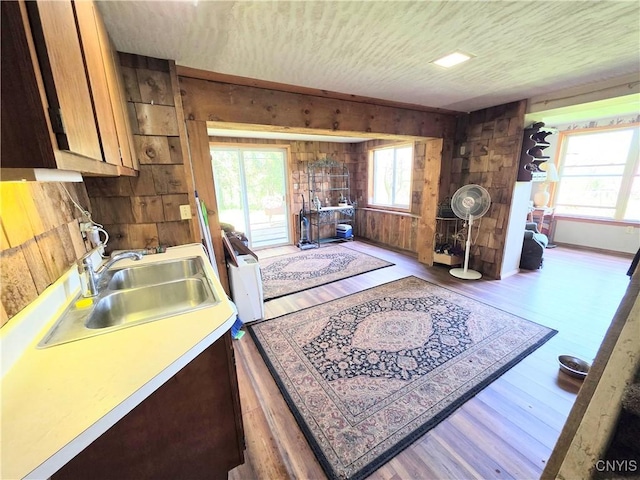 4300 Mutton Hill Rd, Fenner, NY 13035 - kitchen with wooden walls, healthy amount of natural light, a sink, and wood finished floors
