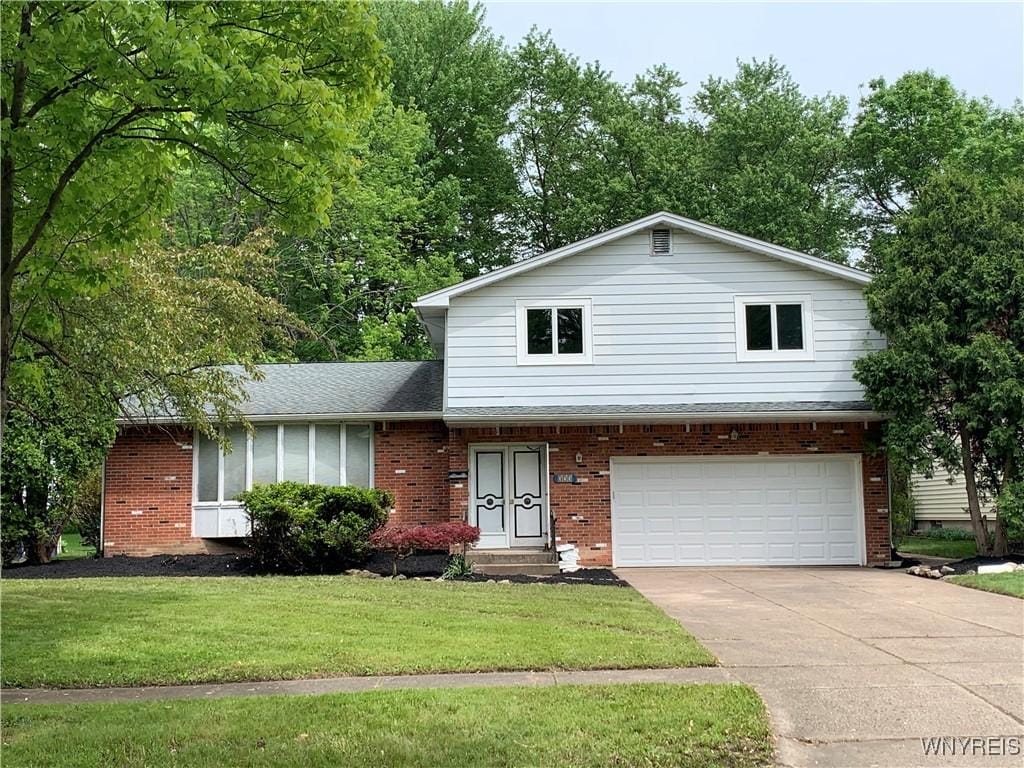 373 Sherbrooke Ave, Amherst, NY 14221 - view of front of home featuring a garage, brick siding, a front yard, and driveway