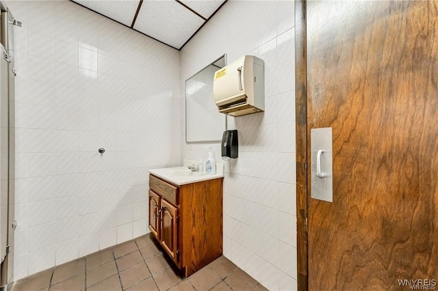 3045 Niagara St, Niagara Falls, NY 14303 - bathroom featuring tile walls, tile patterned floors, and vanity