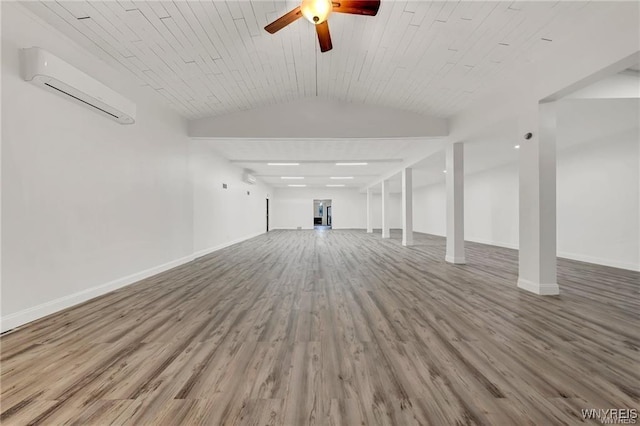3045 Niagara St, Niagara Falls, NY 14303 - unfurnished living room featuring a wall mounted AC, wood finished floors, baseboards, a ceiling fan, and vaulted ceiling