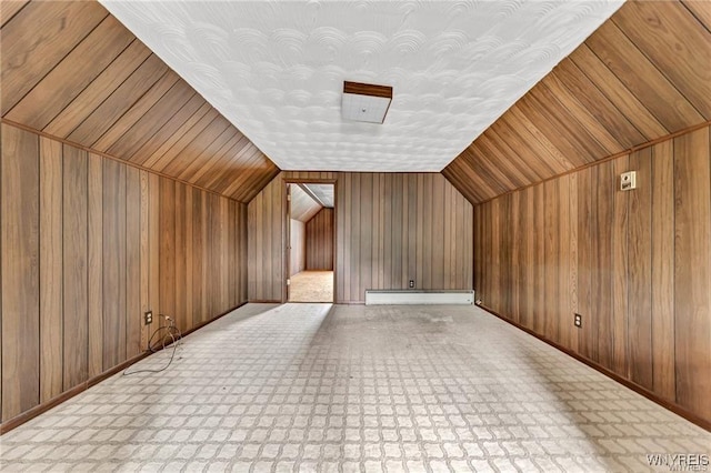 3045 Niagara St, Niagara Falls, NY 14303 - additional living space with baseboard heating, wood walls, vaulted ceiling, and baseboards