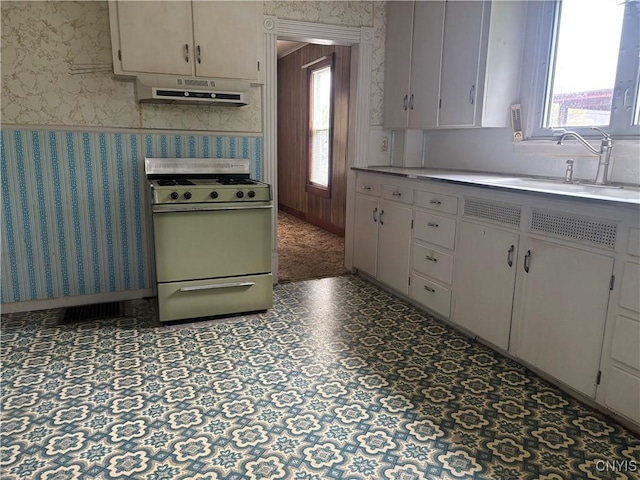 10 Otter Creek Pl, Cortland, NY 13045 - kitchen featuring range with gas cooktop, under cabinet range hood, wallpapered walls, a sink, and light countertops