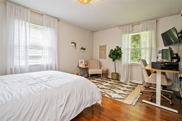 669 Webster Rd, Webster, NY 14580 - bedroom featuring wood finished floors, an office area, and baseboards