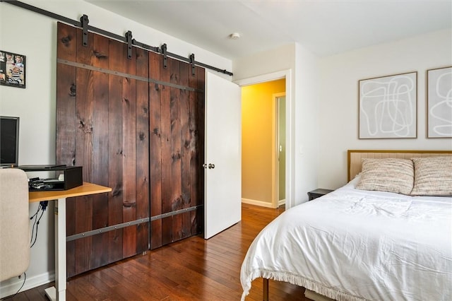 669 Webster Rd, Webster, NY 14580 - bedroom with a barn door, hardwood / wood-style floors, and baseboards