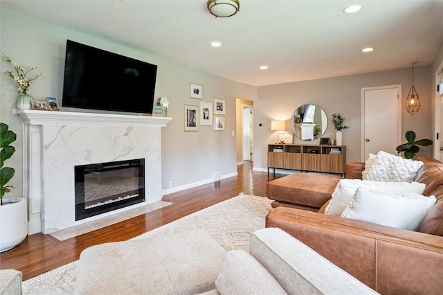 669 Webster Rd, Webster, NY 14580 - living room with a premium fireplace, wood finished floors, recessed lighting, and baseboards