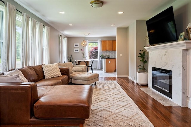 669 Webster Rd, Webster, NY 14580 - living room featuring dark wood-type flooring, recessed lighting, a fireplace, and baseboards