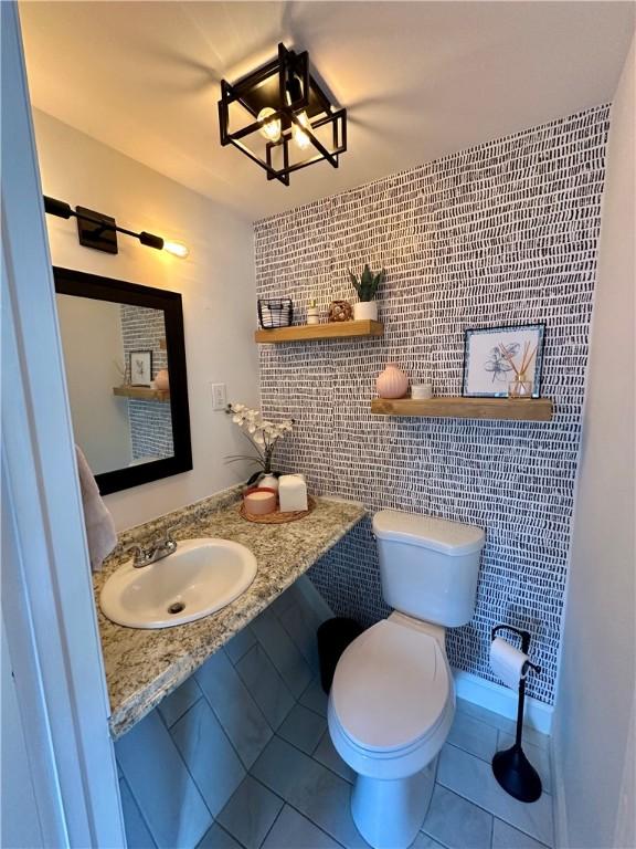 669 Webster Rd, Webster, NY 14580 - bathroom featuring a sink, tile walls, tile patterned floors, and toilet
