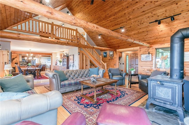 3996 Donley Rd, Italy, NY 14512 - living room featuring stairway, a chandelier, high vaulted ceiling, a wood stove, and wood ceiling