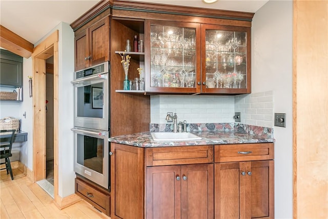 3996 Donley Rd, Italy, NY 14512 - indoor wet bar featuring double oven, decorative backsplash, and light wood-style flooring