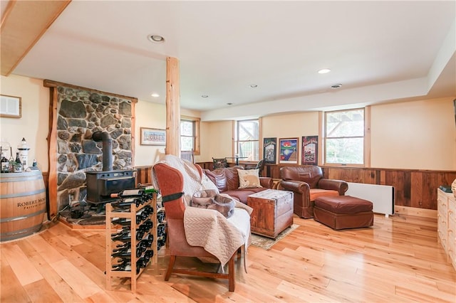 3996 Donley Rd, Italy, NY 14512 - living area featuring a wood stove, wood-type flooring, a wainscoted wall, radiator heating unit, and recessed lighting