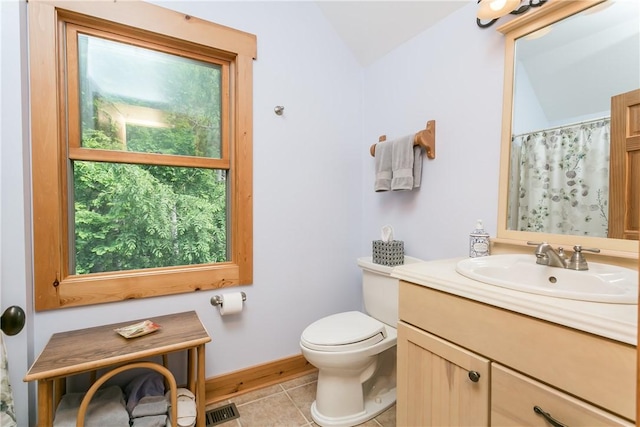 3996 Donley Rd, Italy, NY 14512 - full bathroom with vanity, vaulted ceiling, toilet, tile patterned flooring, and baseboards