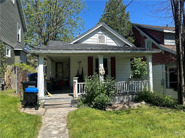 319 Shuart Ave, Syracuse, NY 13203 - bungalow featuring a porch, a front yard, and roof with shingles