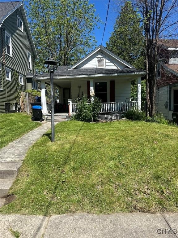 319 Shuart Ave, Syracuse, NY 13203 - view of front of property featuring covered porch, a front lawn, driveway, and a carport