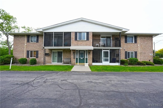 1162 Indian Church Rd Unit 8, West Seneca, NY 14224 - view of front of house with a sunroom, brick siding, and a balcony