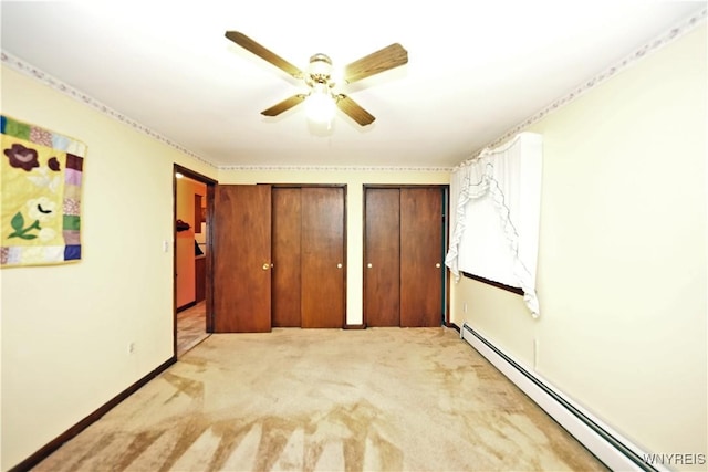 1162 Indian Church Rd Unit 8, West Seneca, NY 14224 - unfurnished bedroom featuring a baseboard radiator, light colored carpet, multiple closets, a ceiling fan, and baseboards