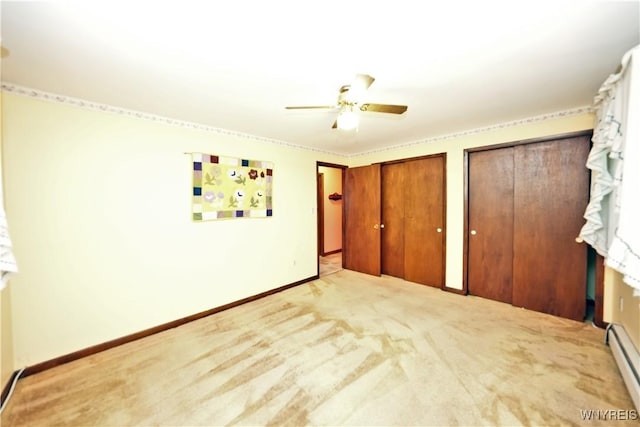 1162 Indian Church Rd Unit 8, West Seneca, NY 14224 - unfurnished bedroom featuring baseboard heating, multiple closets, baseboards, carpet floors, and a ceiling fan
