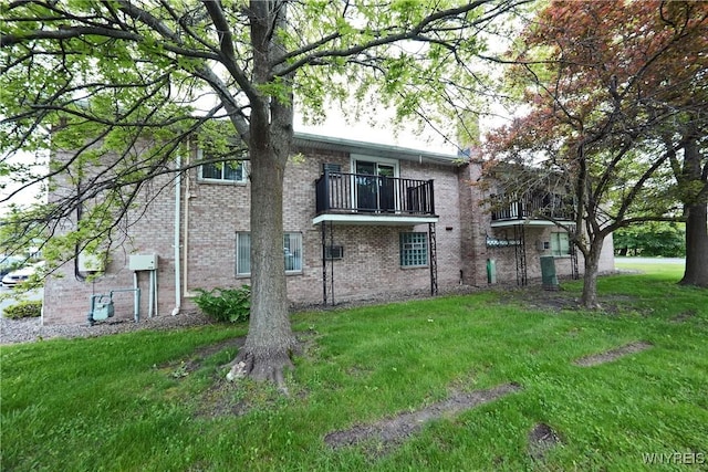1162 Indian Church Rd Unit 8, West Seneca, NY 14224 - back of property with a balcony, brick siding, and a lawn
