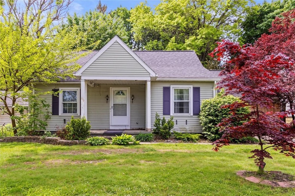 109 Britton Rd, Rochester, NY 14612 - bungalow-style home with a porch, a front lawn, and a shingled roof
