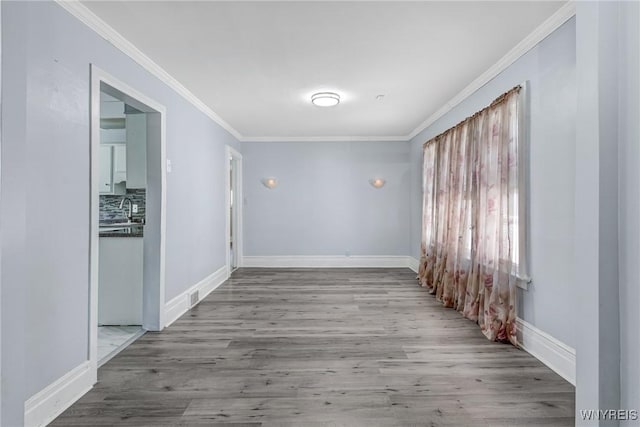 46 Wilkes Ave, Buffalo, NY 14215 - spare room with crown molding, wood finished floors, a sink, and baseboards