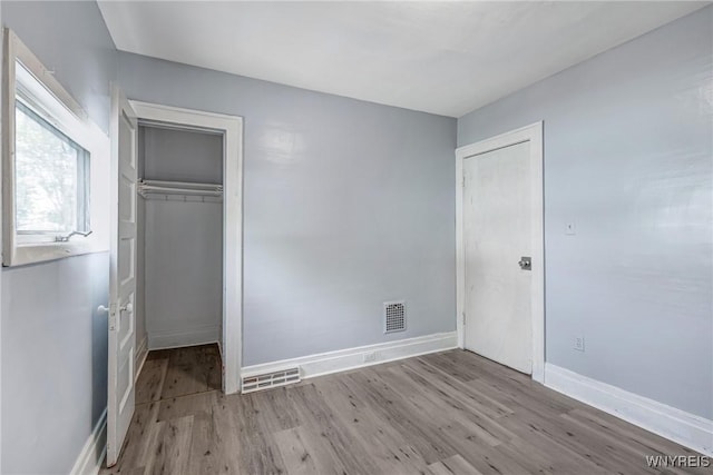 46 Wilkes Ave, Buffalo, NY 14215 - unfurnished bedroom with wood finished floors, a closet, and baseboards
