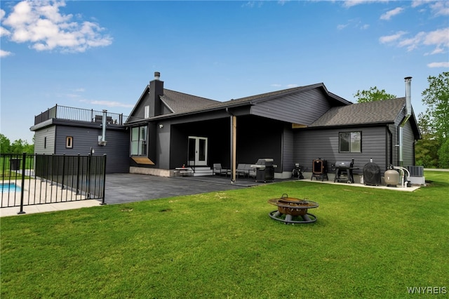 3333 Beebe Rd, Wilson, NY 14108 - rear view of property featuring a fire pit, a patio, french doors, and a shingled roof