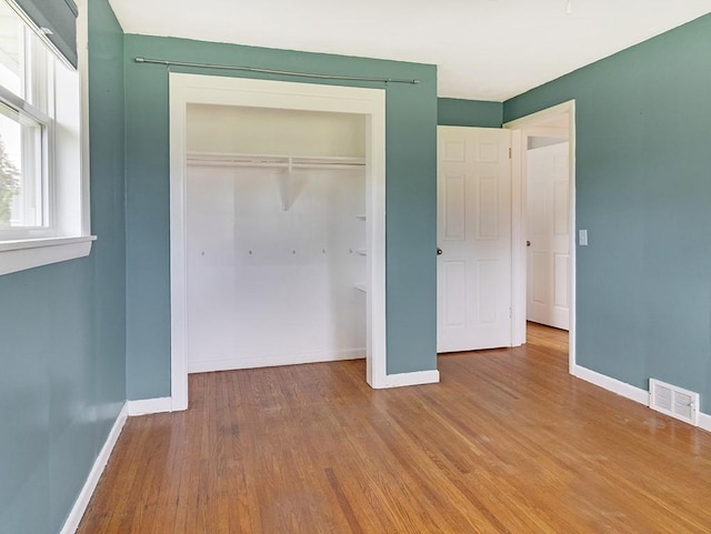 13 W Crest Dr, Gates, NY 14606 - unfurnished bedroom with baseboards, wood finished floors, and a closet