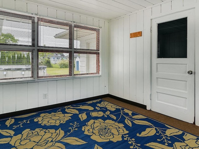 13 W Crest Dr, Gates, NY 14606 - unfurnished room featuring dark colored carpet and wood walls