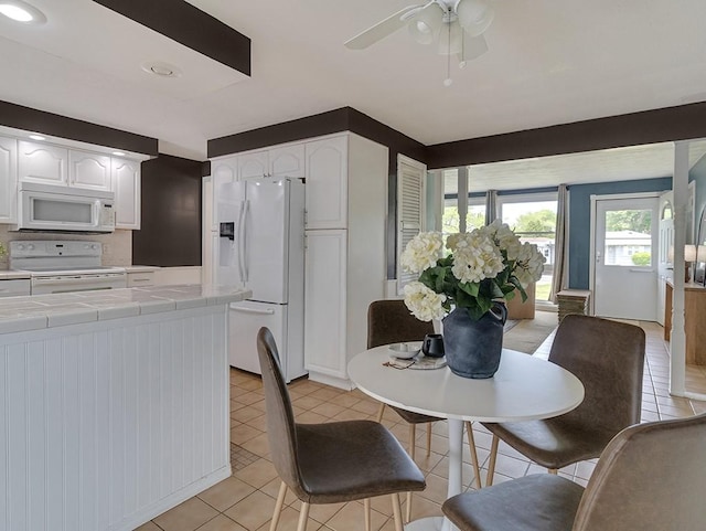 13 W Crest Dr, Gates, NY 14606 - dining area with ceiling fan and light tile patterned floors