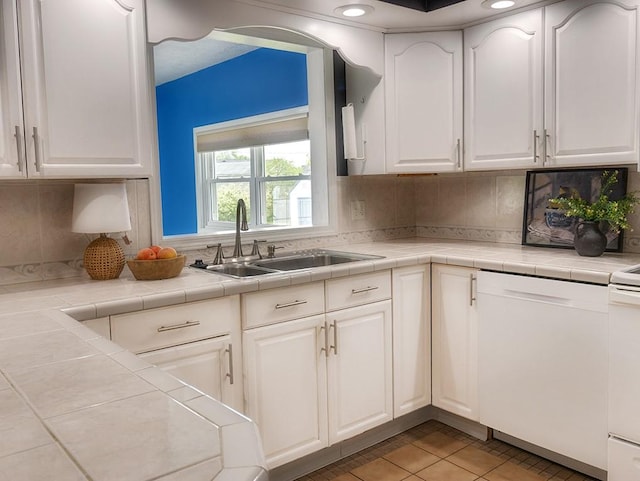 13 W Crest Dr, Gates, NY 14606 - kitchen with a sink, white dishwasher, white cabinetry, light tile patterned flooring, and tasteful backsplash