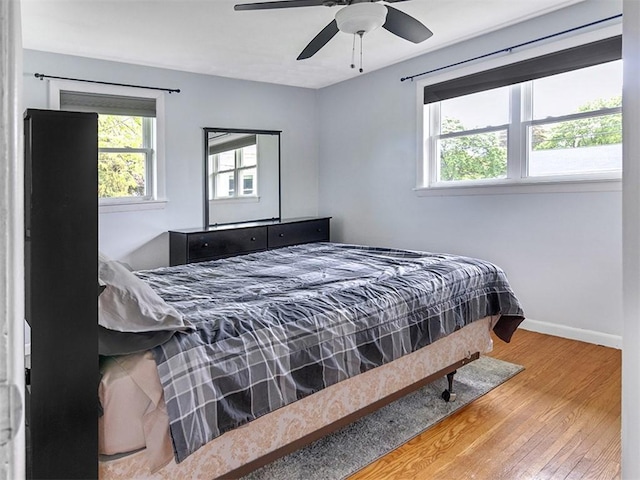 13 W Crest Dr, Gates, NY 14606 - bedroom featuring multiple windows, wood finished floors, baseboards, and ceiling fan