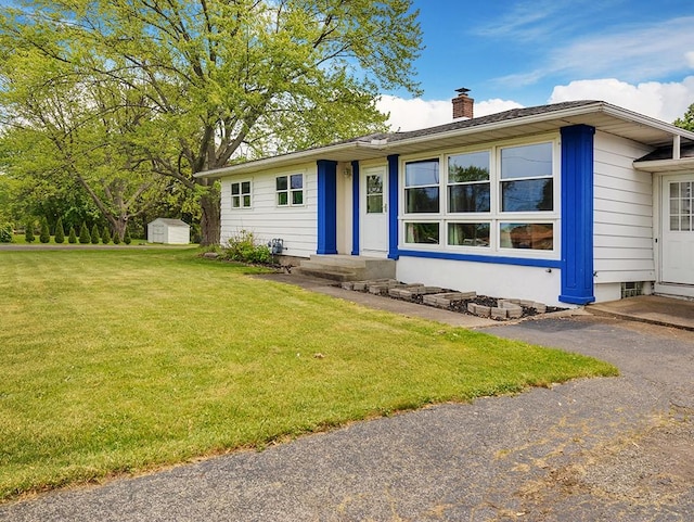 13 W Crest Dr, Gates, NY 14606 - view of front of home with a chimney, a front yard, and entry steps