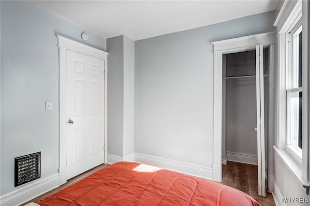 57 Davidson Ave, Buffalo, NY 14215 - unfurnished bedroom with wood finished floors, a closet, and baseboards