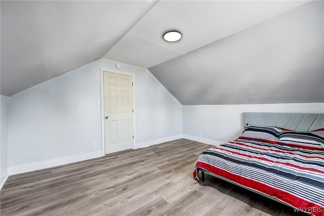 57 Davidson Ave, Buffalo, NY 14215 - bedroom featuring wood finished floors, baseboards, and vaulted ceiling