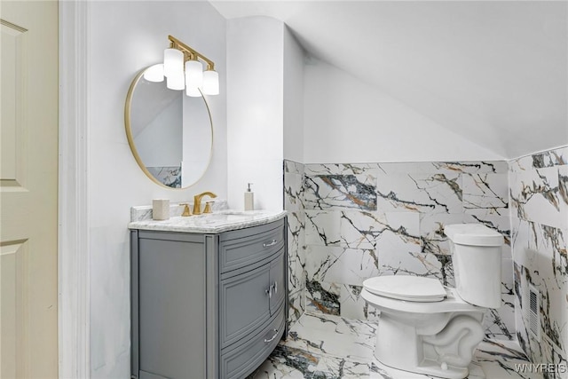 57 Davidson Ave, Buffalo, NY 14215 - bathroom with marble finish flooring, vanity, toilet, and lofted ceiling