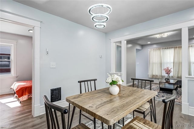 57 Davidson Ave, Buffalo, NY 14215 - dining area featuring baseboards, wood finished floors, and a chandelier