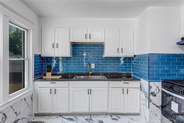 57 Davidson Ave, Buffalo, NY 14215 - kitchen with a sink, range with gas cooktop, light marble finish floors, white cabinets, and dark stone counters