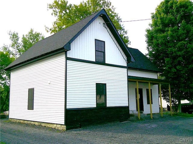 8457 S Main St, Le Ray, NY 13637 - view of side of home with a shingled roof and board and batten siding