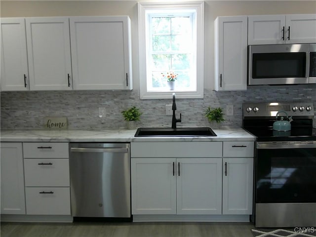 8457 S Main St, Le Ray, NY 13637 - kitchen featuring appliances with stainless steel finishes, a sink, and tasteful backsplash