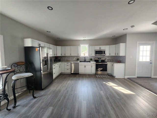 8457 S Main St, Le Ray, NY 13637 - kitchen with stainless steel appliances, tasteful backsplash, wood finished floors, white cabinetry, and recessed lighting