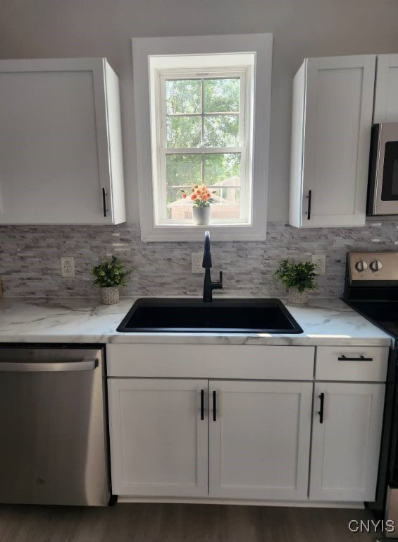 8457 S Main St, Le Ray, NY 13637 - kitchen featuring appliances with stainless steel finishes, light stone counters, and white cabinets